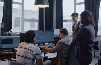 The web and software development team at 5150media® working together in the office.